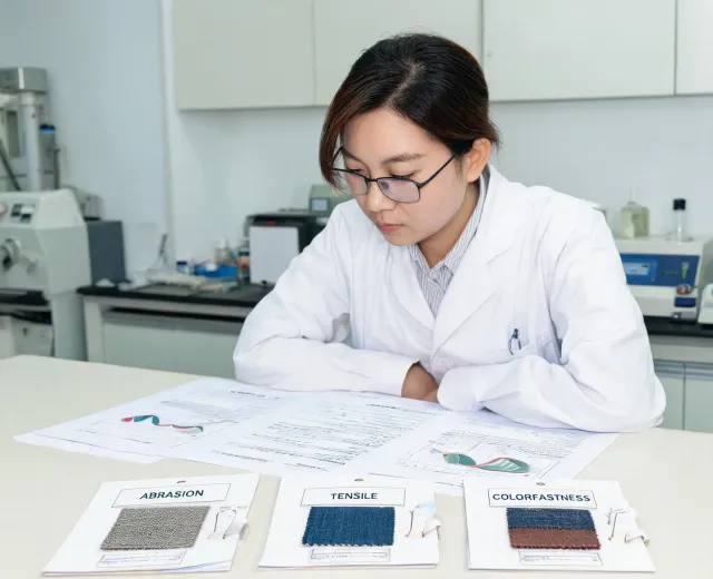 Textile technologist reviewing test methods
